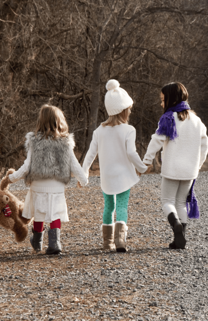 kids walking in nature holding hands - Northwest Indiana Nannies